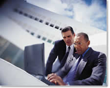 Image of Two Businessmen working on a Laptop